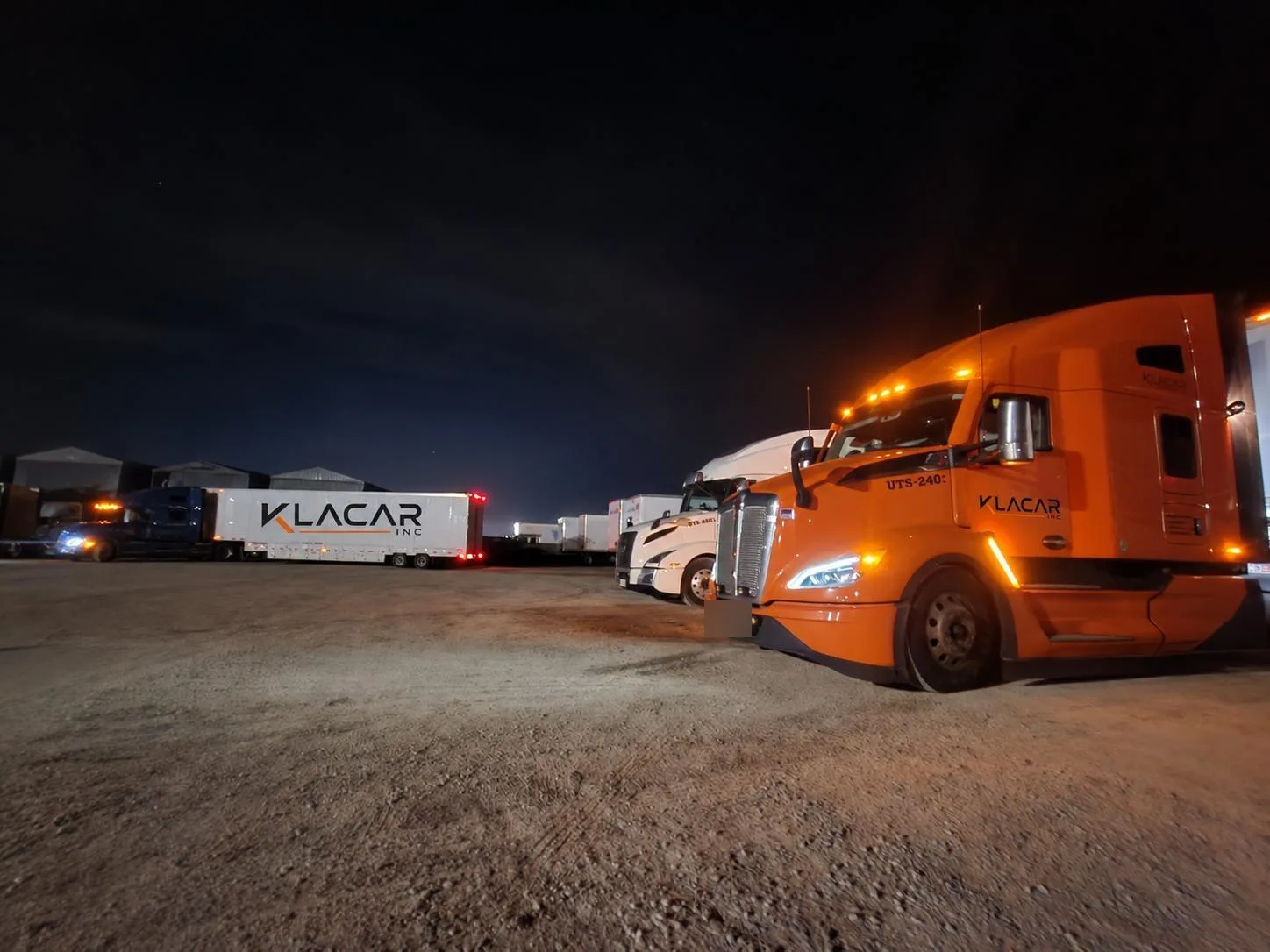 Klacar tractors parked in the yard at night