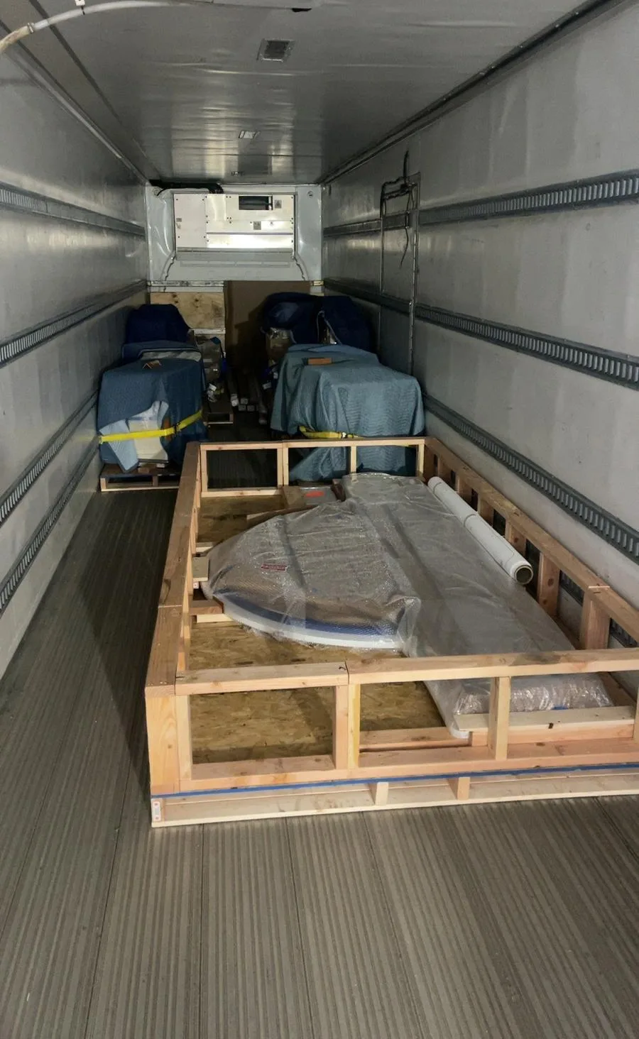 A crated item on a pallet inside a Klacar trailer