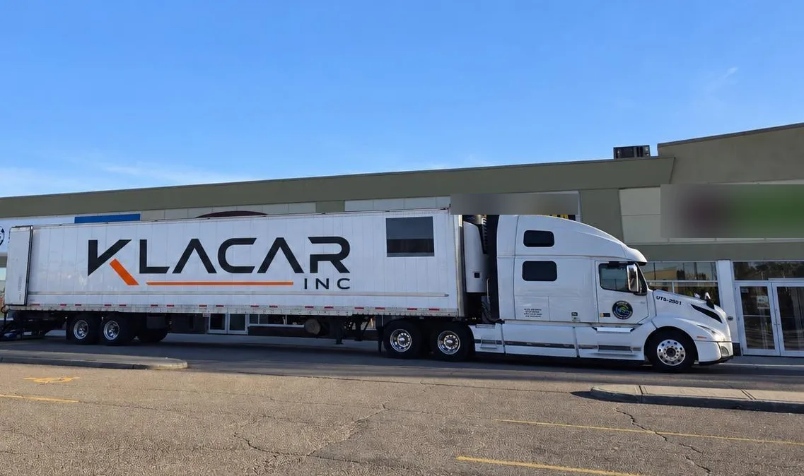 Klacar tractor and trailer with the company logo